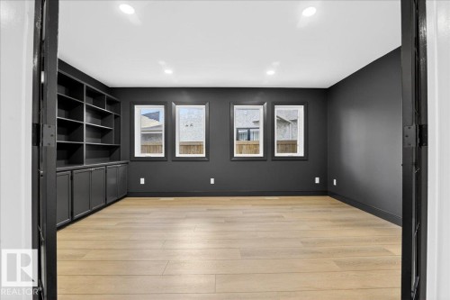 Unfurnished room with light wood-style floors, built in features, and recessed lighting - 218 Omand Drive, Edmonton, AB 
