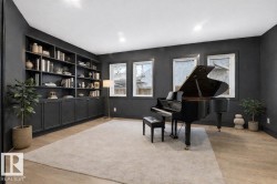 Sitting room with light wood-type flooring, recessed lighting, and built in shelves - 