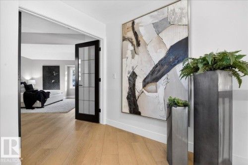 Hall featuring wood-type flooring and french doors - 218 Omand Drive, Edmonton, AB 