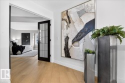 Hall featuring wood-type flooring and french doors - 