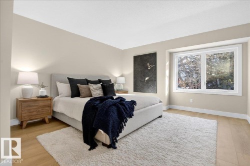 Bedroom with baseboards and light wood-style flooring - 218 Omand Drive, Edmonton, AB 