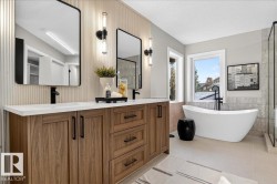 Bathroom featuring a stall shower, tile walls, vanity, a freestanding bath, and a textured ceiling - 