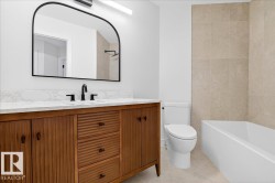 Bathroom featuring vanity, light tile patterned floors, tile walls, and shower / tub combination - 