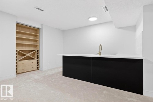 Bar with light carpet, modern cabinets, dark cabinets, a textured ceiling, and open shelves - 218 Omand Drive, Edmonton, AB 