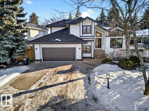 Contemporary home with stucco siding, driveway, and an attached garage - 218 Omand Drive, Edmonton, AB 