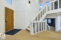 Entrance foyer featuring wood finished floors and a high ceiling - 