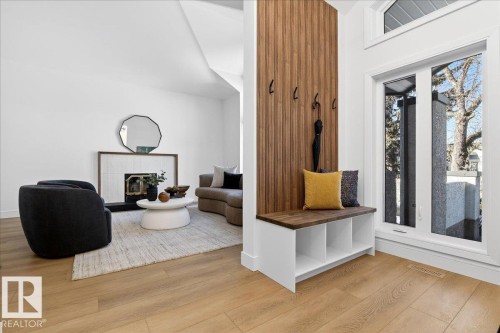Mudroom featuring a tiled fireplace and light wood finished floors - 218 Omand Drive, Edmonton, AB 