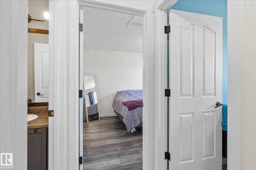 Bedroom featuring dark wood-type flooring - 3015 49, Beaumont, AB - Indoor