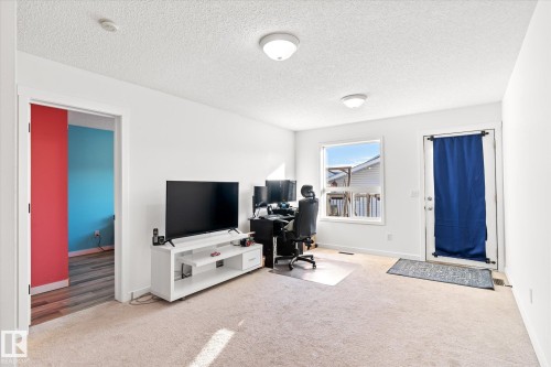 Office space featuring light carpet and a textured ceiling - 3015 49, Beaumont, AB - Indoor