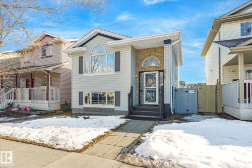 View of front of property with a gate and a porch - 3015 49, Beaumont, AB - Outdoor With Facade