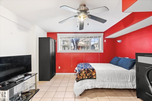 Bedroom featuring ceiling fan and light tile patterned flooring - 3015 49, Beaumont, AB - Indoor Photo Showing Bedroom