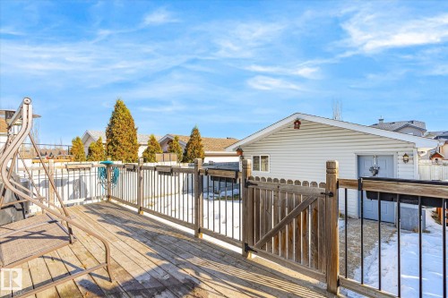 Wooden deck with a residential view and a gate - 3015 49, Beaumont, AB - Outdoor With Deck Patio Veranda With Exterior