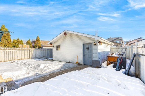 Snow covered house featuring a fenced backyard and an outbuilding - 3015 49, Beaumont, AB - Outdoor