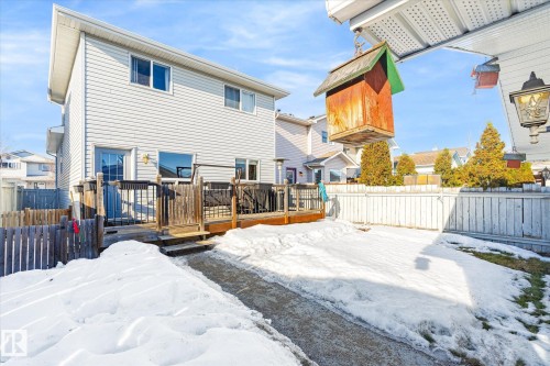 Snow covered rear of property featuring a deck and a fenced backyard - 3015 49, Beaumont, AB - Outdoor With Deck Patio Veranda With Exterior