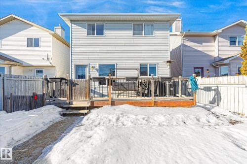 Snow covered property featuring a wooden deck and a fenced backyard - 3015 49, Beaumont, AB - Outdoor With Deck Patio Veranda