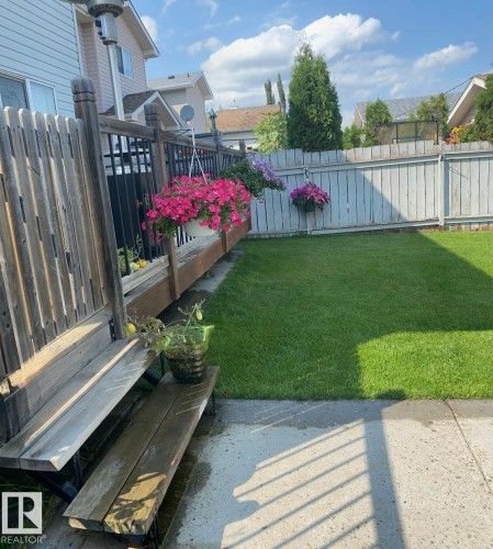 Fenced backyard with a deck - 3015 49, Beaumont, AB - Outdoor With Deck Patio Veranda