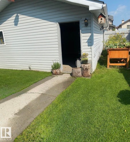 View of side of home with a yard - 3015 49, Beaumont, AB - Outdoor