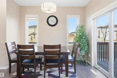 Dining area featuring dark wood-style floors and baseboards - 5003 Andison Close, Edmonton, AB - Indoor Photo Showing Dining Room