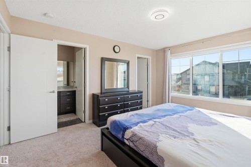 Bedroom featuring light colored carpet and connected bathroom - 5003 Andison Close, Edmonton, AB - Indoor Photo Showing Bedroom