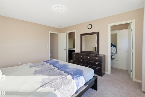 Bedroom with ensuite bath and light carpet - 5003 Andison Close, Edmonton, AB - Indoor Photo Showing Bedroom