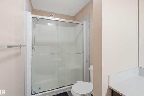 Bathroom with a textured ceiling, a shower stall, and vanity - 5003 Andison Close, Edmonton, AB - Indoor Photo Showing Bathroom