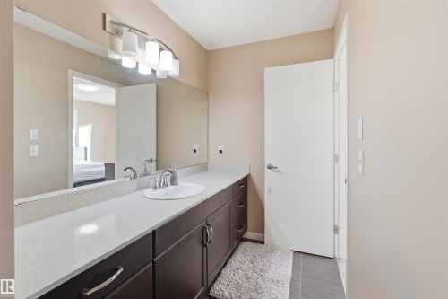 Bathroom featuring vanity and light tile patterned flooring - 5003 Andison Close, Edmonton, AB - Indoor Photo Showing Bathroom