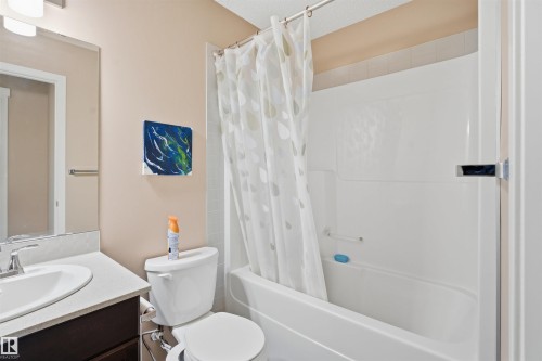 Bathroom with vanity and shower / bath combination with curtain - 5003 Andison Close, Edmonton, AB - Indoor Photo Showing Bathroom