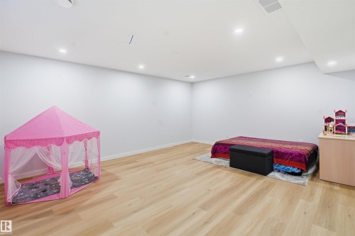 Recreation room featuring light wood-style flooring and recessed lighting - 5003 Andison Close, Edmonton, AB - Indoor