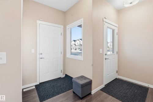 Entrance foyer featuring wood finished floors - 5003 Andison Close, Edmonton, AB - Indoor Photo Showing Other Room