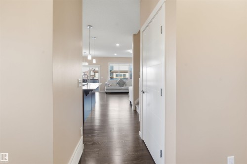 Hallway with dark wood finished floors and recessed lighting - 5003 Andison Close, Edmonton, AB - Indoor Photo Showing Other Room
