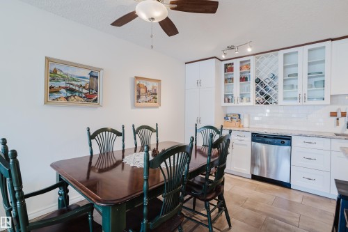 Dining space featuring ceiling fan, light wood-style floors, and a textured ceiling - 115 10545 Saskatchewan Drive, Edmonton, AB - Indoor