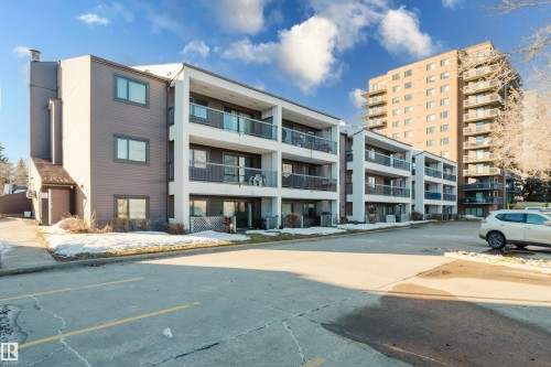 View of apartment building / complex with uncovered parking - 115 10545 Saskatchewan Drive, Edmonton, AB - Outdoor With Facade