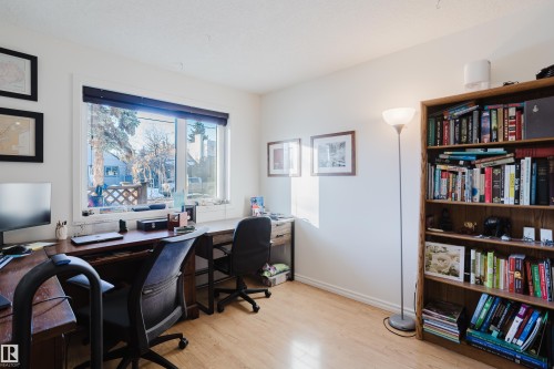 Office area with light wood-style flooring and baseboards - 115 10545 Saskatchewan Drive, Edmonton, AB - Indoor Photo Showing Office