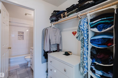 Walk in closet with light tile patterned floors - 115 10545 Saskatchewan Drive, Edmonton, AB - Indoor