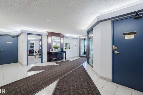 Building lobby with a textured ceiling - 115 10545 Saskatchewan Drive, Edmonton, AB - Indoor Photo Showing Other Room