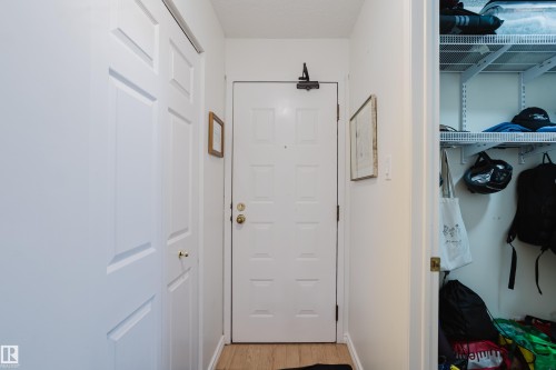 Doorway featuring wood finished floors - 115 10545 Saskatchewan Drive, Edmonton, AB - Indoor Photo Showing Other Room