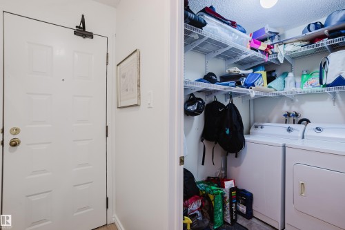Laundry area with separate washer and dryer and a textured ceiling - 115 10545 Saskatchewan Drive, Edmonton, AB - Indoor Photo Showing Laundry Room