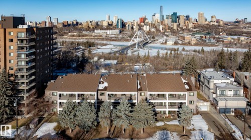 Snowy aerial view featuring a skyline view - 115 10545 Saskatchewan Drive, Edmonton, AB - Outdoor With View