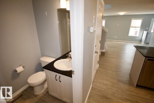 Half bathroom with vanity and dark wood finished floors - Upper 516 Ebbers Way, Edmonton, AB - Indoor Photo Showing Bathroom