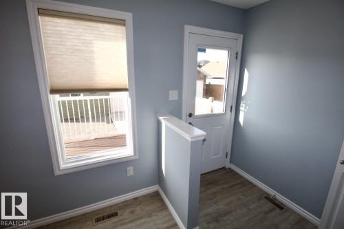 Doorway to outside with wood finished floors - Upper 516 Ebbers Way, Edmonton, AB - Indoor Photo Showing Other Room