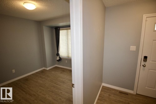 Spare room with a textured ceiling and dark wood-type flooring - Upper 516 Ebbers Way, Edmonton, AB - Indoor Photo Showing Other Room