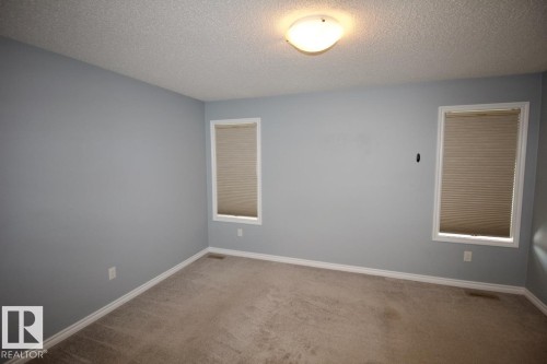 Spare room featuring a textured ceiling and carpet - Upper 516 Ebbers Way, Edmonton, AB - Indoor Photo Showing Other Room