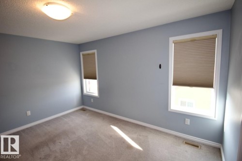 Carpeted spare room with baseboards - Upper 516 Ebbers Way, Edmonton, AB - Indoor Photo Showing Other Room