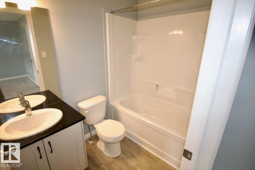 Full bath with vanity, shower / bath combination, and light wood-style flooring - Upper 516 Ebbers Way, Edmonton, AB - Indoor Photo Showing Bathroom