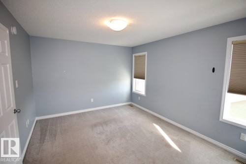 Empty room with light carpet and a textured ceiling - Upper 516 Ebbers Way, Edmonton, AB - Indoor Photo Showing Other Room