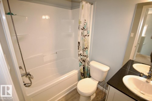 Bathroom featuring shower / bath combo with shower curtain and vanity - Upper 516 Ebbers Way, Edmonton, AB - Indoor Photo Showing Bathroom