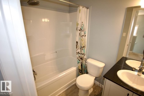 Full bath featuring shower / bath combo and vanity - Upper 516 Ebbers Way, Edmonton, AB - Indoor Photo Showing Bathroom