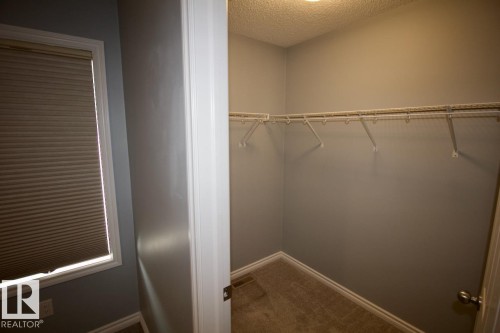 Walk in closet featuring dark carpet - Upper 516 Ebbers Way, Edmonton, AB - Indoor With Storage