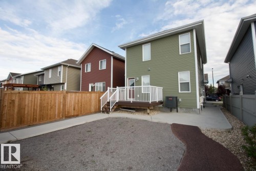 Back of house featuring a wooden deck and a residential view - Upper 516 Ebbers Way, Edmonton, AB - Outdoor With Exterior