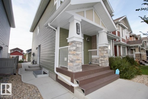 View of property exterior featuring stone siding and covered porch - Upper 516 Ebbers Way, Edmonton, AB - Outdoor